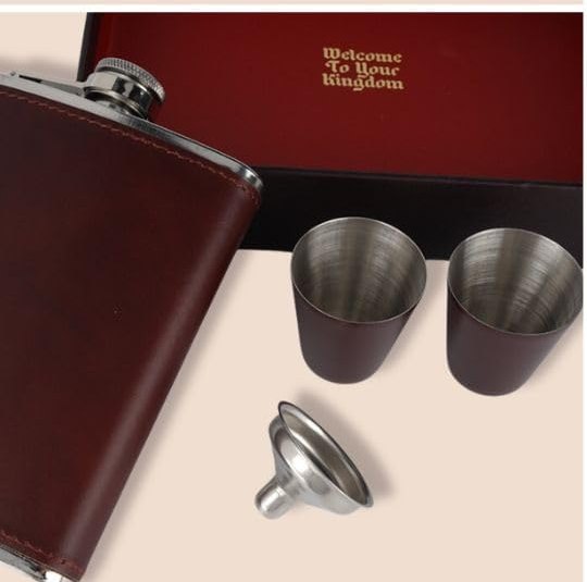 Bourbon being measured into a stainless hip flask with two pony cups alongside